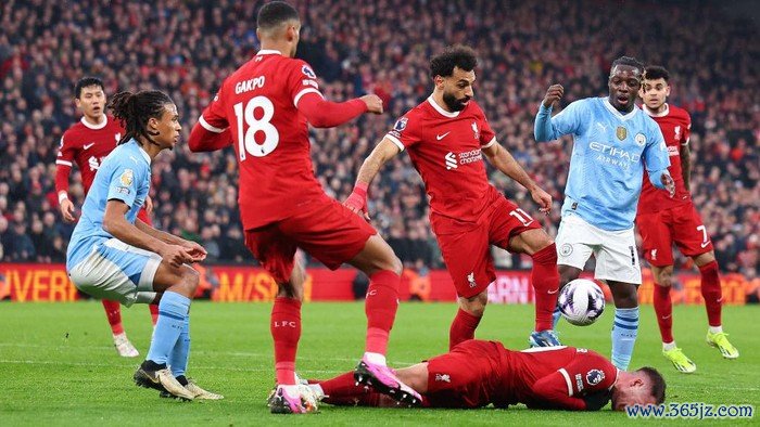 LIVERPOOL, ENGLAND - MARCH 10: Alexis Mac Allister of Liverpool reacts after a tackle by Jérémy Doku of Manchester City during the Premier League match between Liverpool FC and Manchester City at Anfield on March 10, 2024 in Liverpool, England.(Photo by Robbie Jay Barratt - AMA/Getty Images)